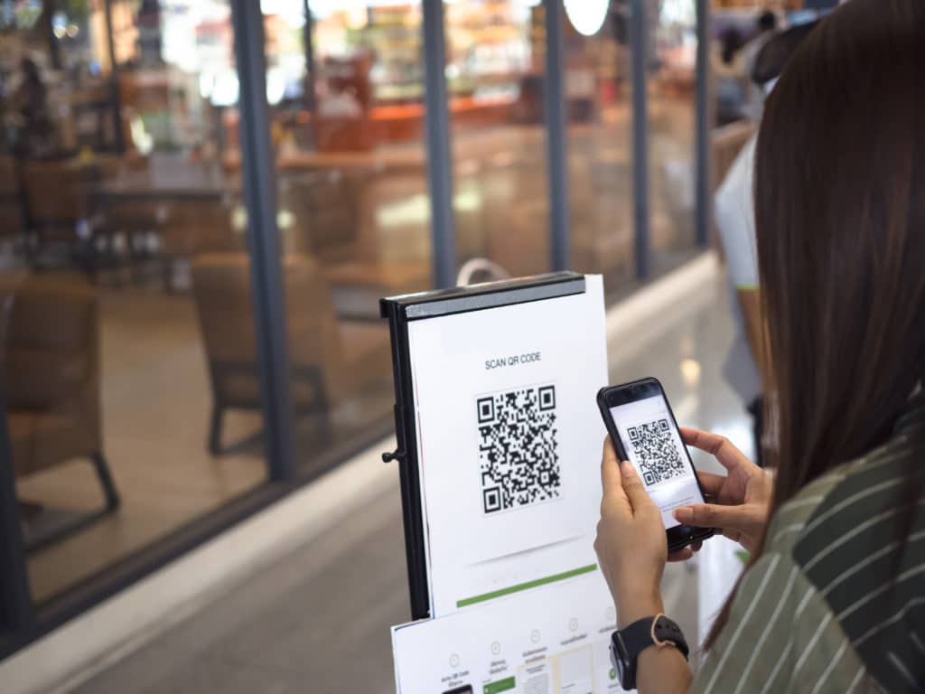 people scan qr code for check in on supermarket or tacking time line, coronavirus or covid 19, new normal